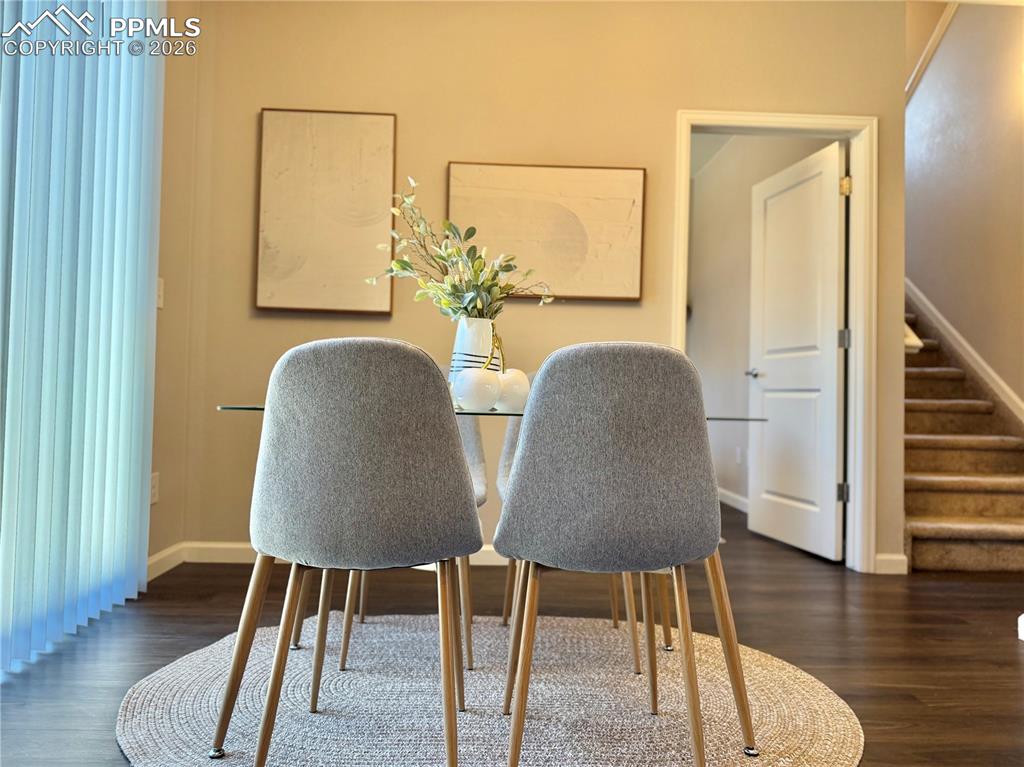 Image 14 of 41: Home office featuring dark wood finished floors and baseboards