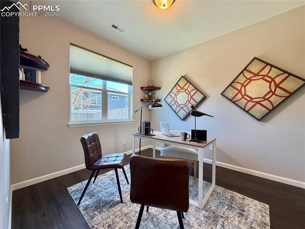 Image 15 of 41: Home office with baseboards and dark wood-style floors