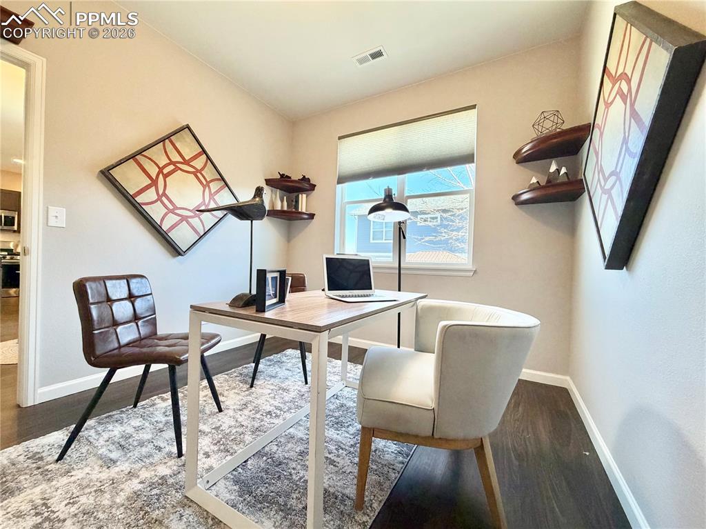 Image 16 of 41: Office featuring baseboards and dark wood-style floors