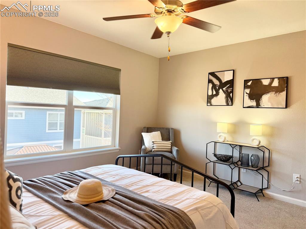 Image 17 of 41: Bedroom with carpet flooring and a ceiling fan
