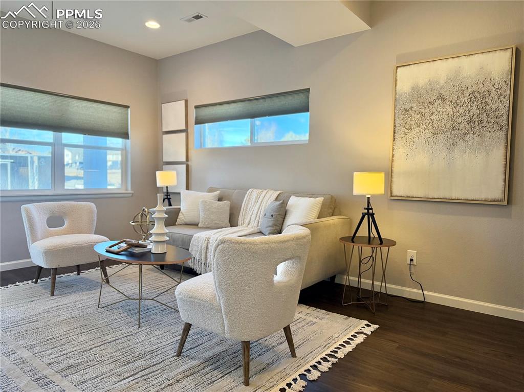 Image 3 of 41: Living area featuring dark wood finished floors and baseboards