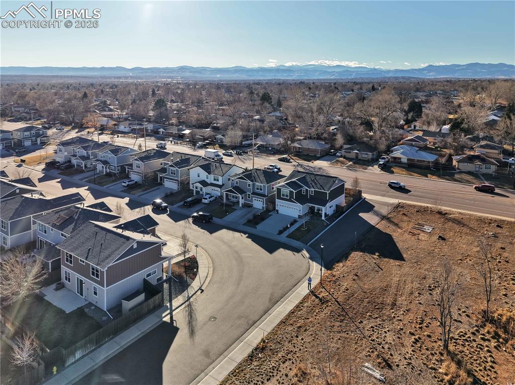 Image 38 of 41: Aerial view of residential area with a mountain backdrop