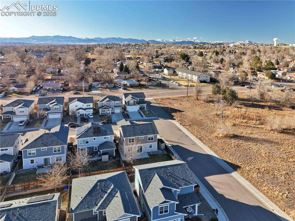 Image 39 of 41: Aerial view of residential area featuring a mountain backdrop