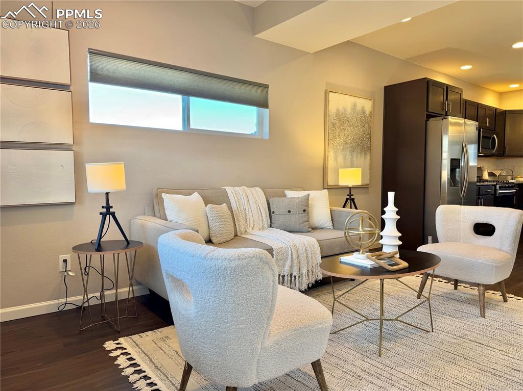 Image 6 of 41: Living area featuring wood finished floors and recessed lighting