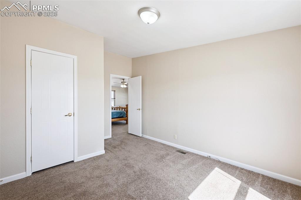 Image 42 of 45: Unfurnished bedroom featuring visible vents, baseboards, and carpet floorin