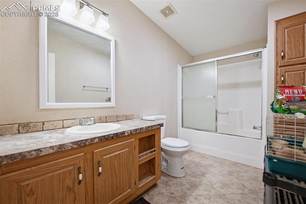 Image 43 of 45: Bathroom featuring vanity, visible vents, toilet, bath / shower combo with 