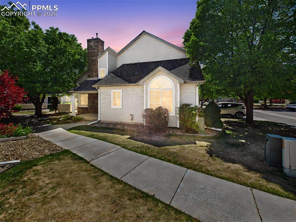 Image 1 of 50: Exterior Front – End-unit location with mature trees and landscaped surroun