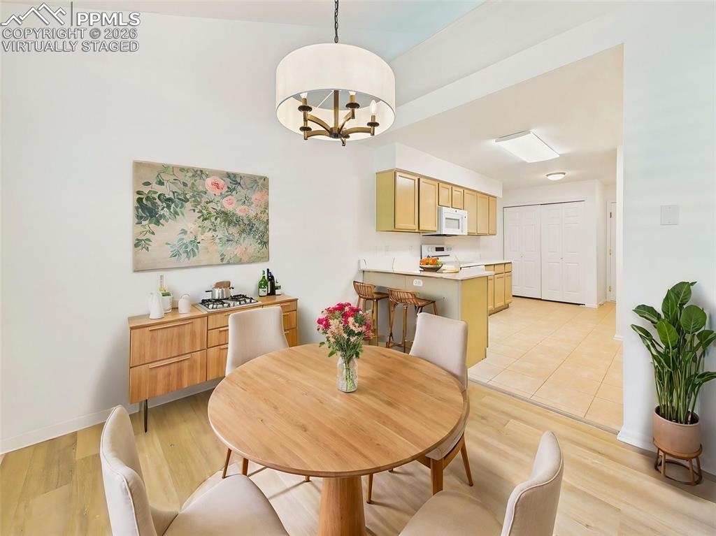 Image 14 of 50: Virtually Staged Open dining area showcasing new flooring and flexible spac