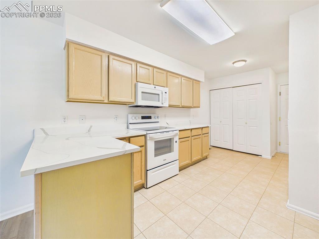 Image 17 of 50: Kitchen (Extended View) – Spacious kitchen with updated finishes, main leve