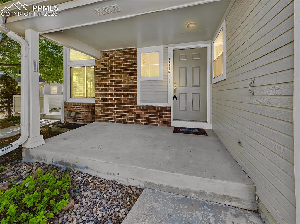 Image 2 of 50: Front Entry / Covered Porch – Private covered front porch with brick accent