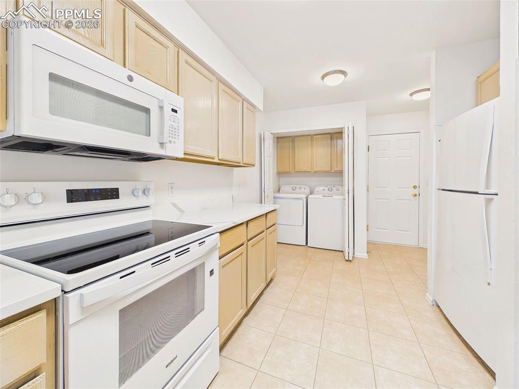 Image 20 of 50: Functional kitchen layout featuring new countertops, updated appliances, an
