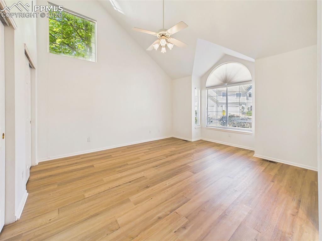 Image 22 of 50: Inviting primary bedroom with vaulted ceilings, stylish finishes, and a cal