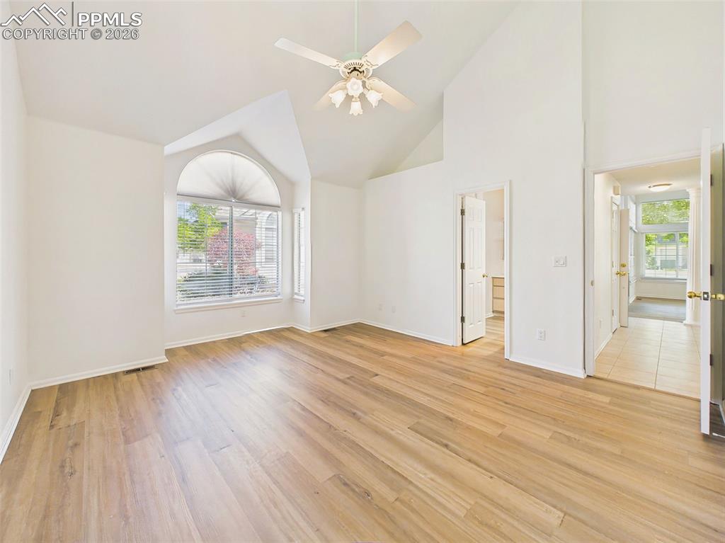 Image 24 of 50: Bright and open primary bedroom with soaring ceilings and flexible layout o