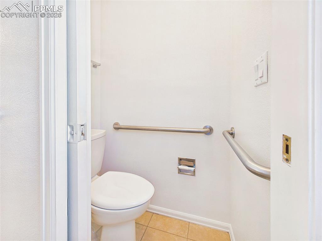 Image 29 of 50: (Toilet Area) – Functional water closet with accessibility features and eas