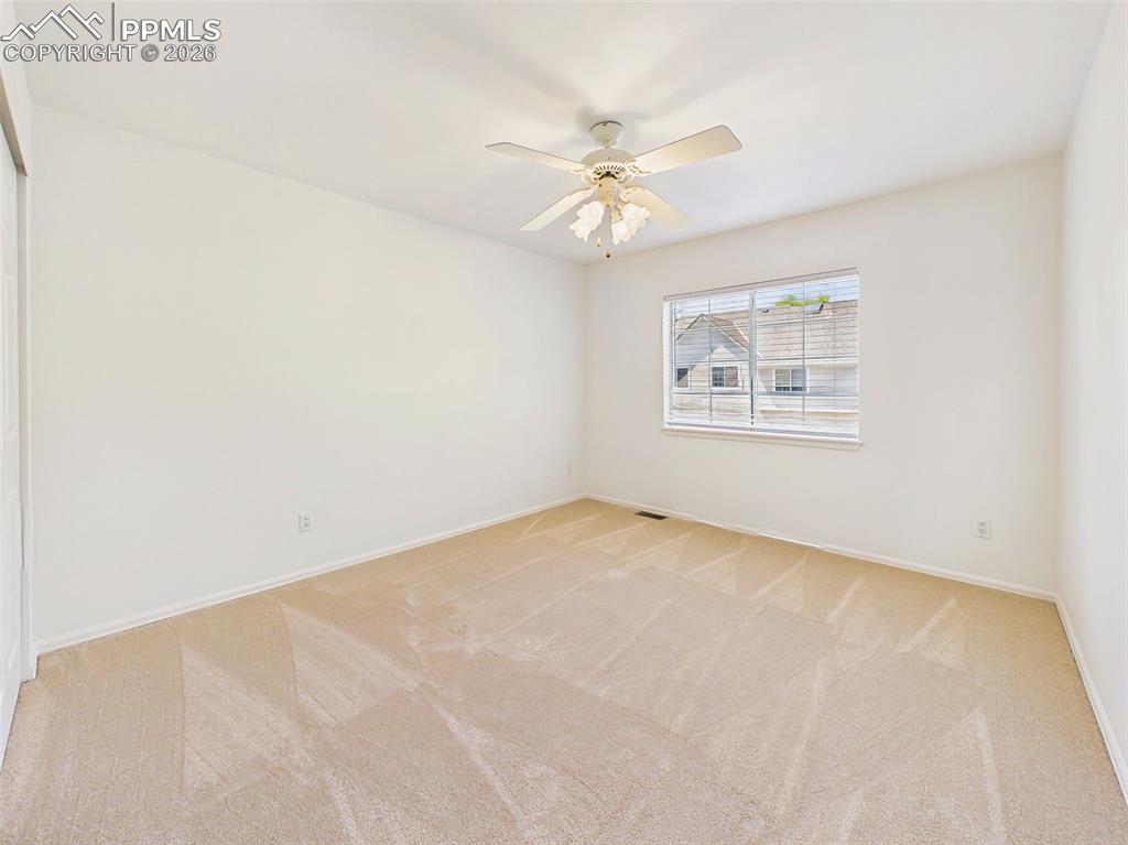 Image 37 of 50: Spacious bedroom with neutral finishes, ample wall space, and flexibility f