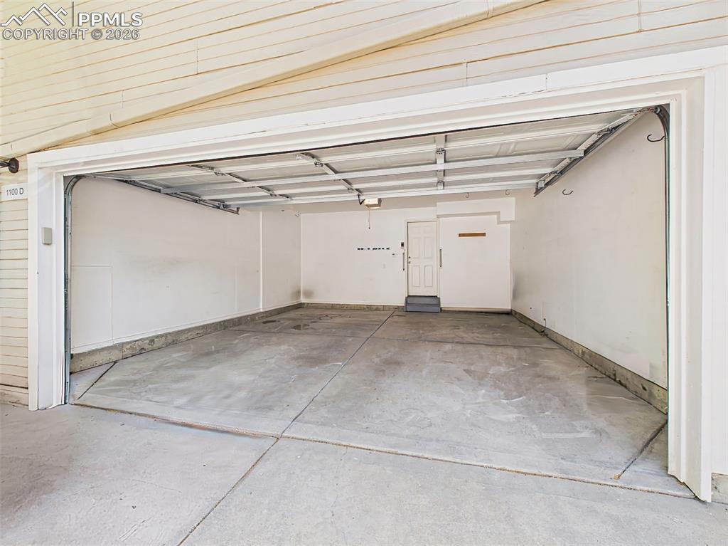 Image 45 of 50: Attached Garage (Interior) – Spacious attached two-car garage with addition