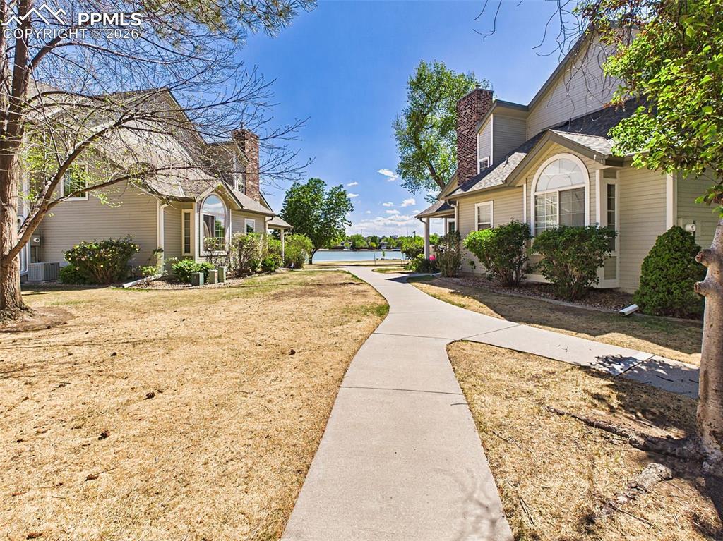 Image 46 of 50: Community Grounds – Charming neighborhood setting with tree-lined walkways 