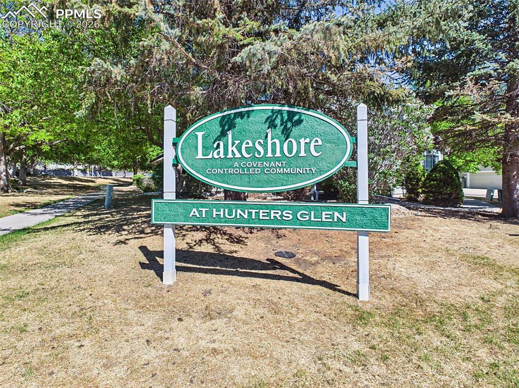 Image 49 of 50: Community Entrance – Welcoming neighborhood entrance with well-maintained l