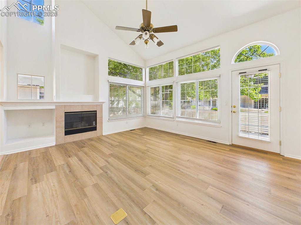 Image 5 of 50: Living Room (Window Wall) – Wall of windows and glass door fill the space w