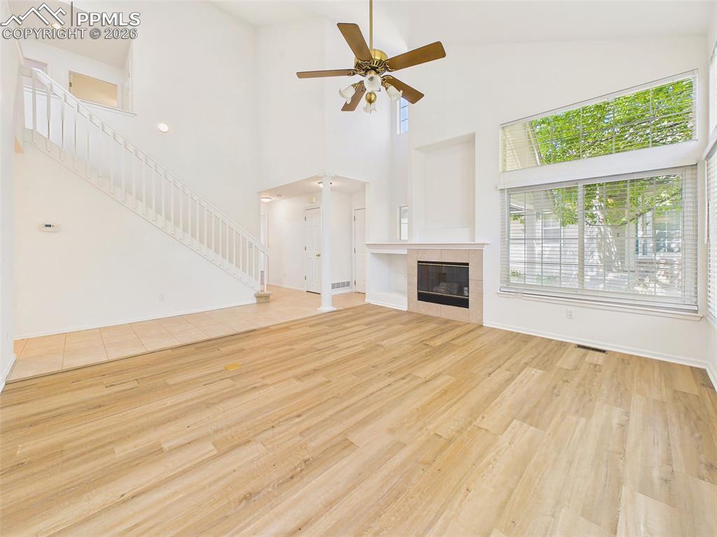 Image 7 of 50: Expansive open-concept living space showcasing new flooring, high ceilings,