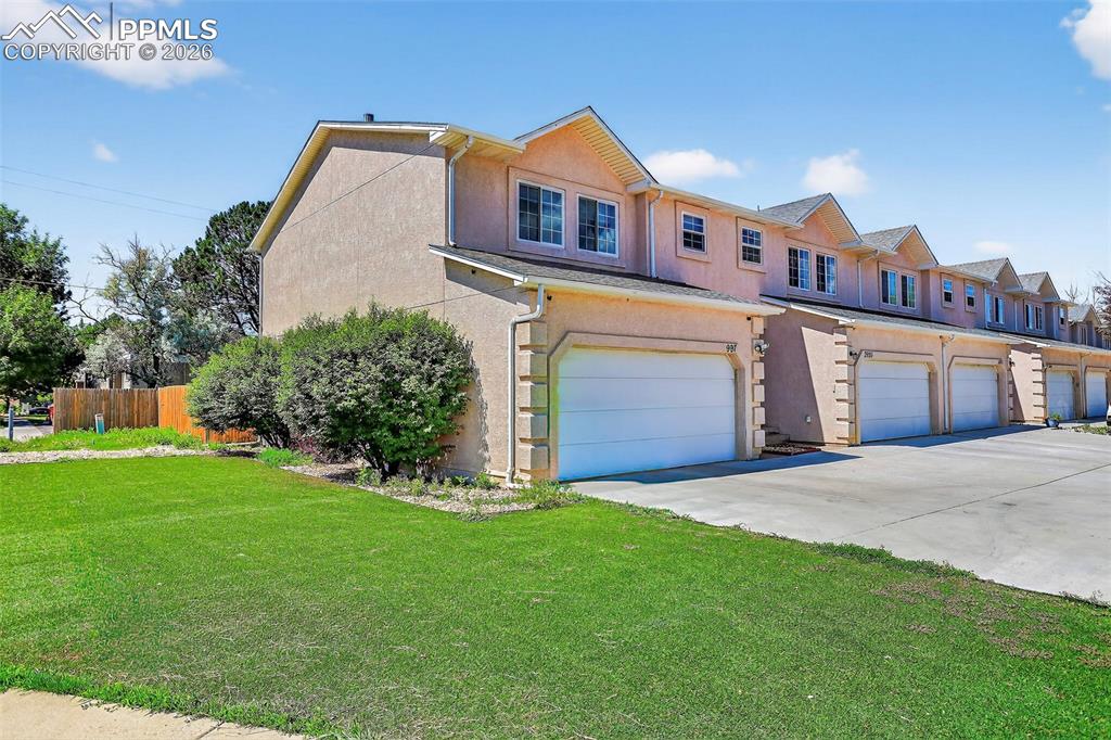 Image 1 of 27: View of front of house featuring a garage, concrete driveway, and stucco si