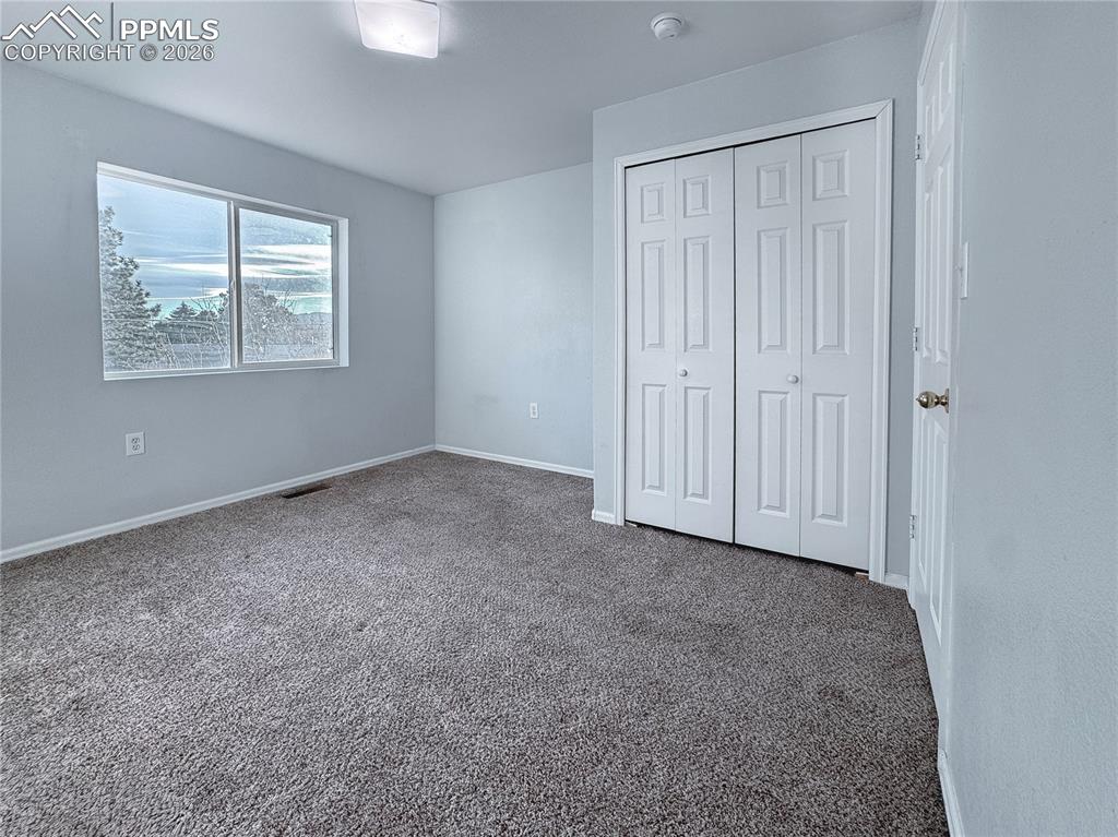 Image 12 of 27: Unfurnished bedroom featuring carpet floors and a closet