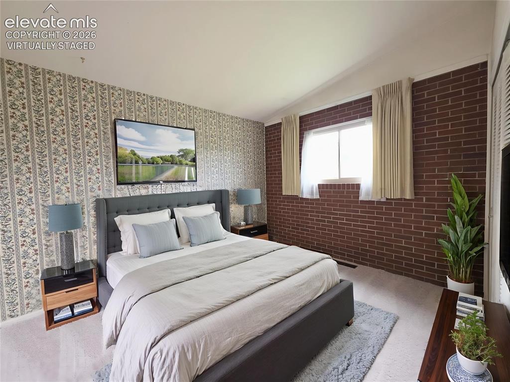 Image 19 of 37: Main level bedroom virtually staged