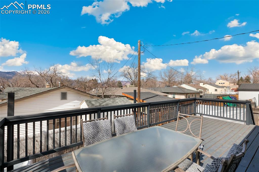 Image 19 of 49: Large wood deck off the upper level kitchen