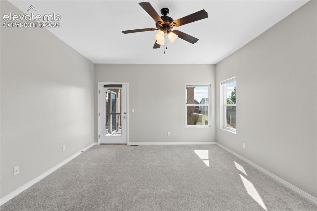 Image 19 of 46: Spacious room featuring light gray carpeting and neutral wall tones