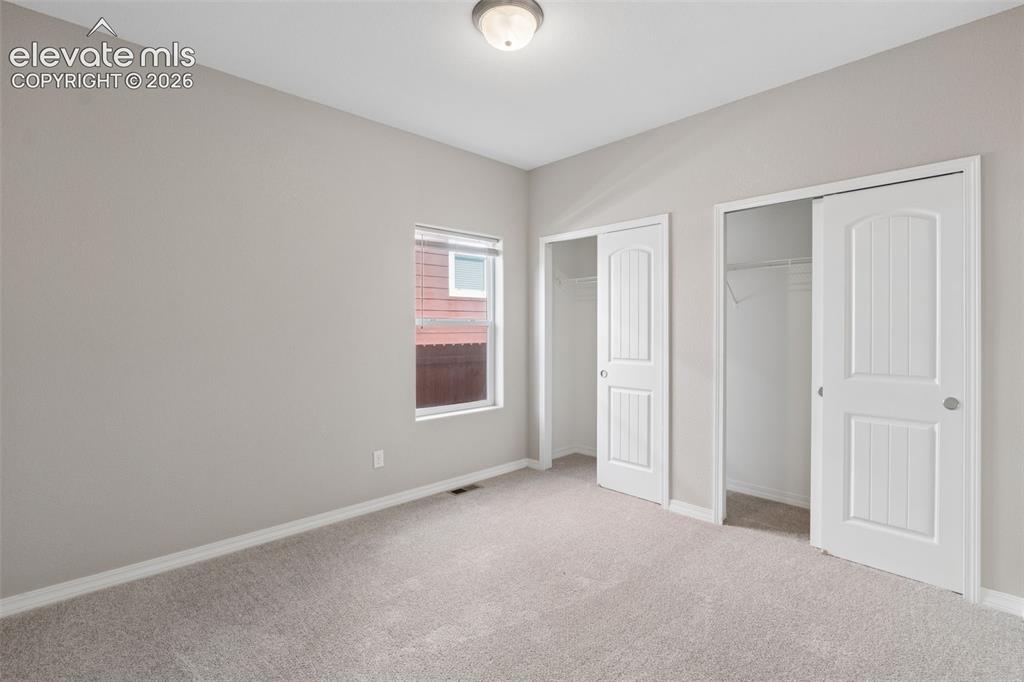 Image 26 of 46: Main Level Bedroom #2 Carpeted room with a ceiling-mounted light fixture, a