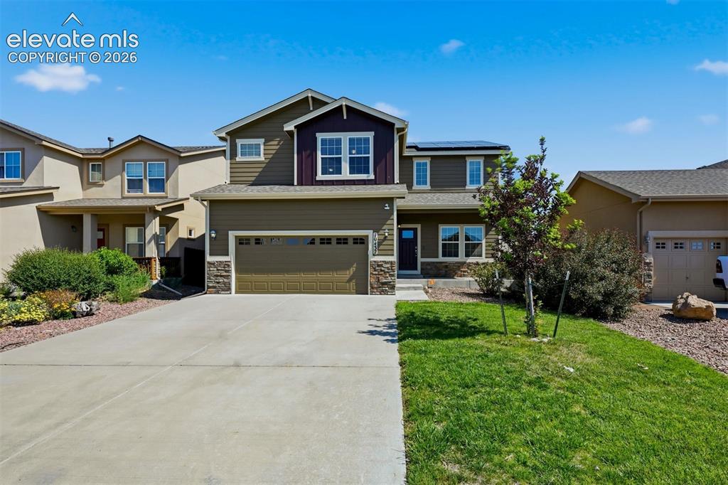 Image 1 of 34: Twilight curb appeal highlights the welcoming covered entry and warm exteri