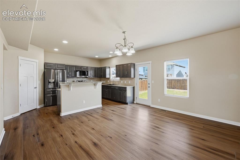 Image 12 of 34: Virtually staged to show how the expansive finished basement can accommodat