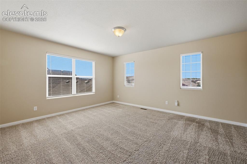 Image 19 of 34: The dining area sits conveniently between the kitchen and living room for a