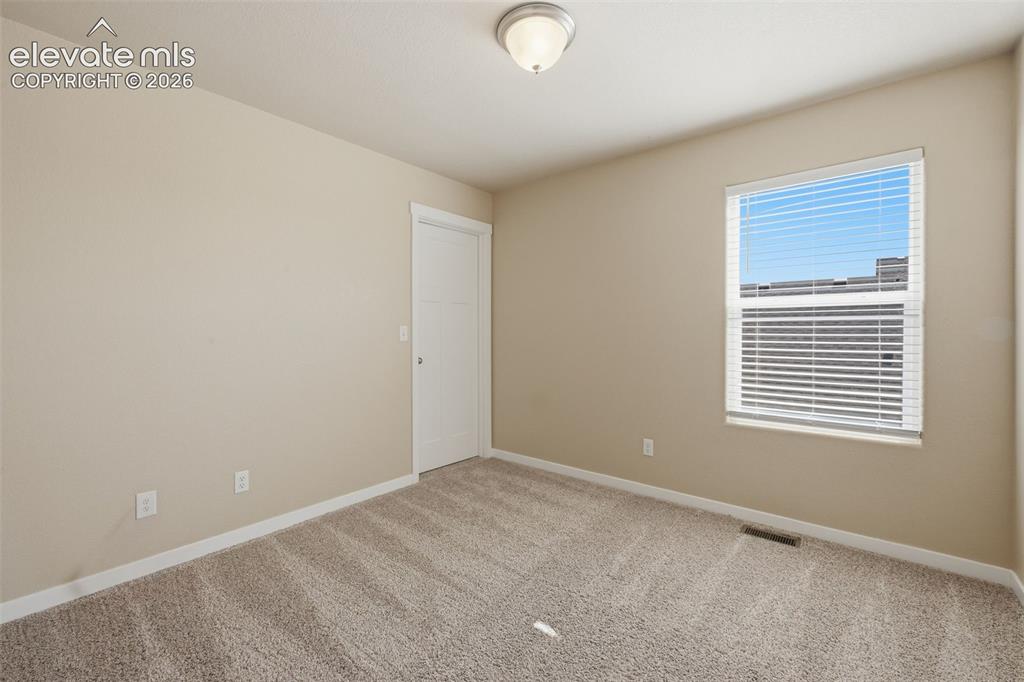 Image 21 of 34: Virtually staged as a home office, this versatile main-level room could als