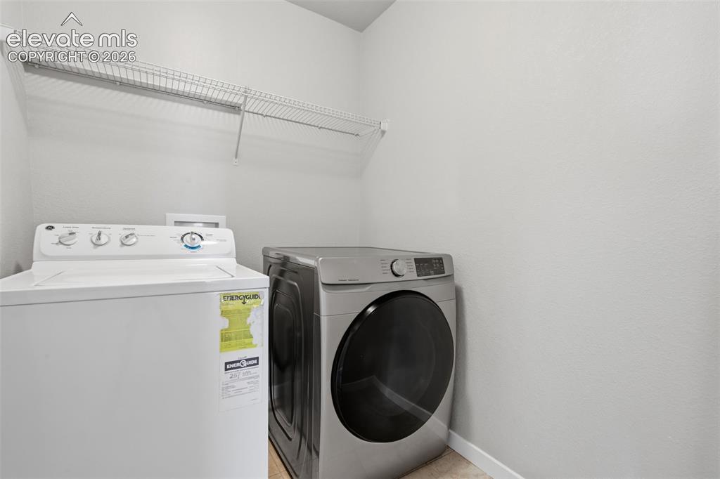 Image 25 of 34: One of three secondary bedrooms upstairs, offering comfortable space and ab