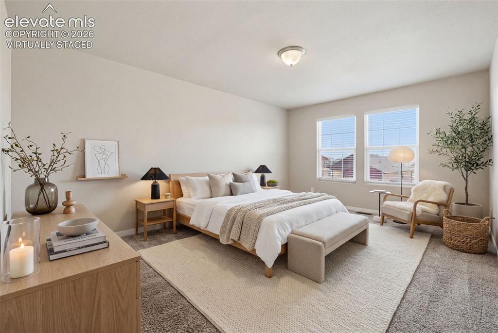 Image 26 of 34: Neutral finishes make this upper-level bedroom easy to personalize for slee