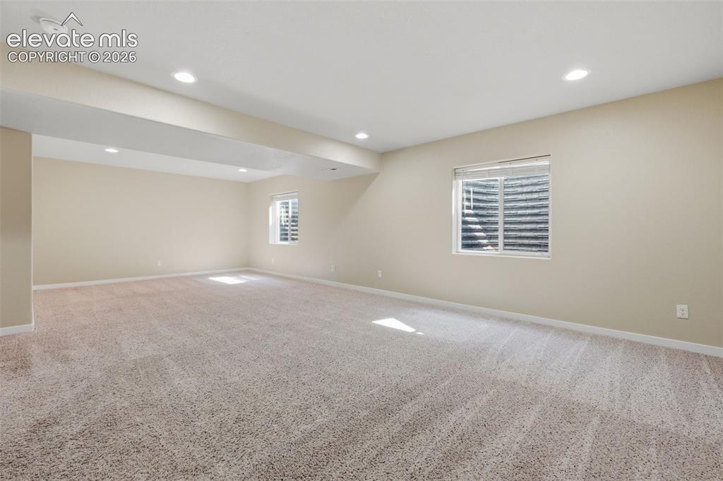 Image 34 of 34: Finished lower level: expansive recreation space, fifth bedroom, full bath