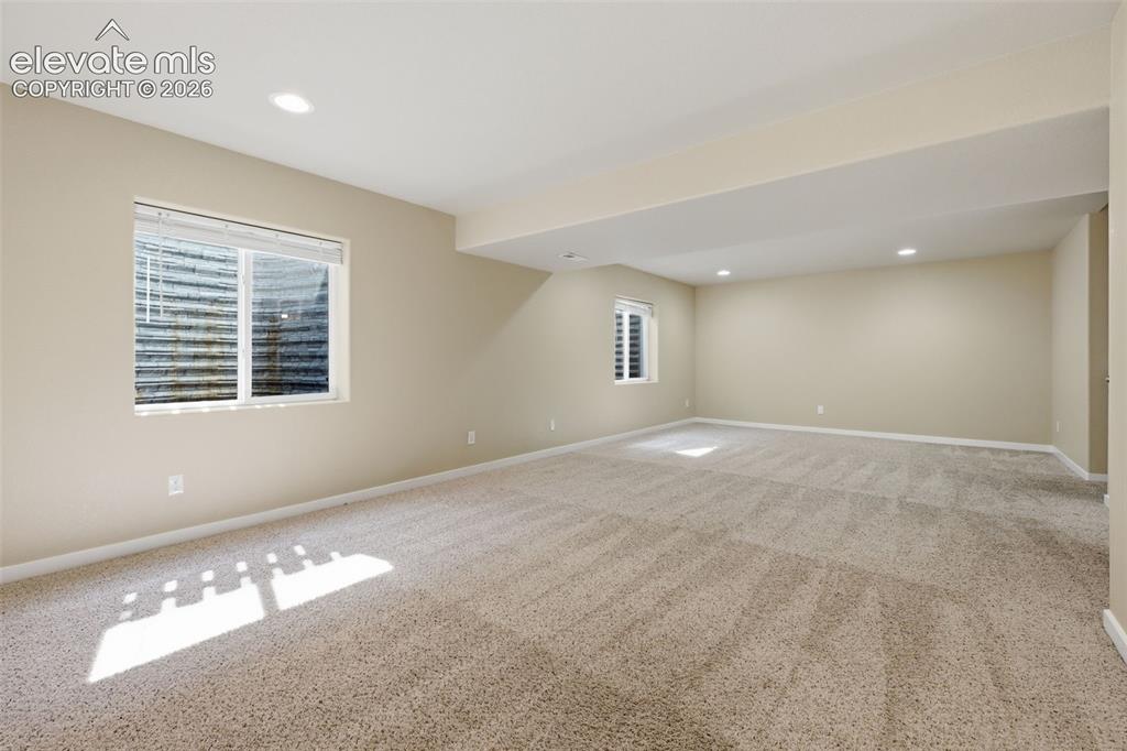 Image 35 of 43: Reverse view of the finished basement with room for media, games, exercise