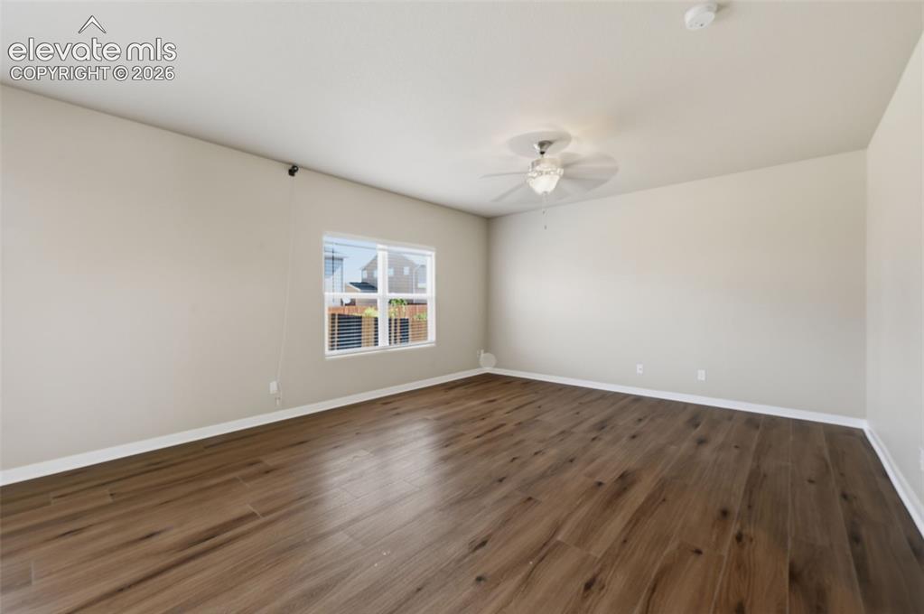 Image 8 of 34: Multiple windows bring natural light into the spacious primary bedroom.