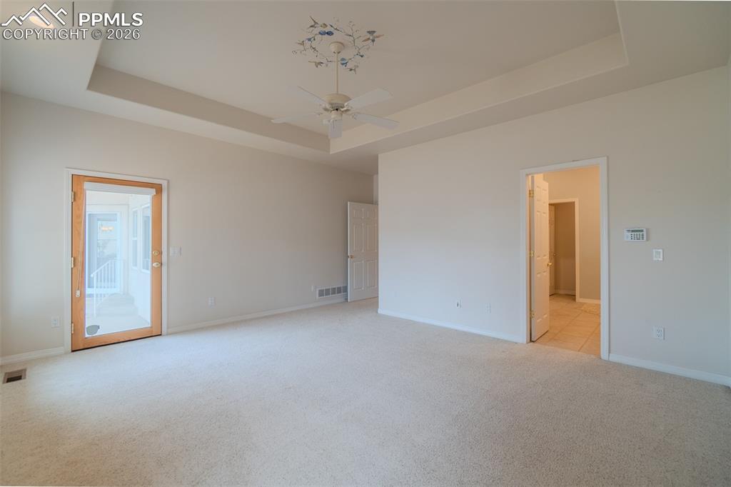Image 22 of 50: Primary Bedroom with Door to the back patio