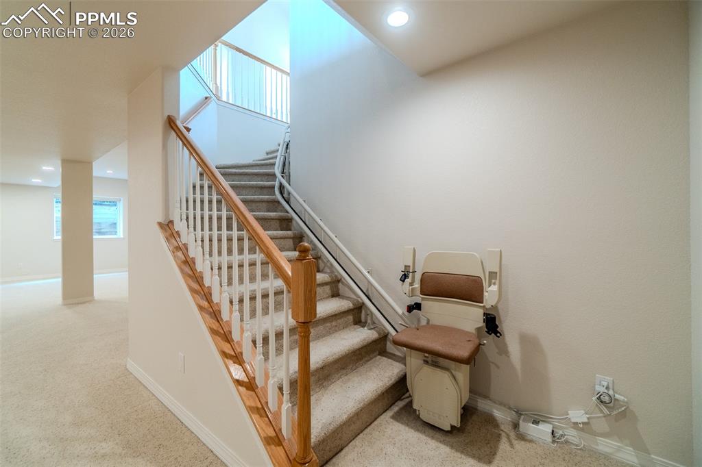 Image 29 of 50: Stairs with carpet flooring and recessed lighting and Shannah brand Electri