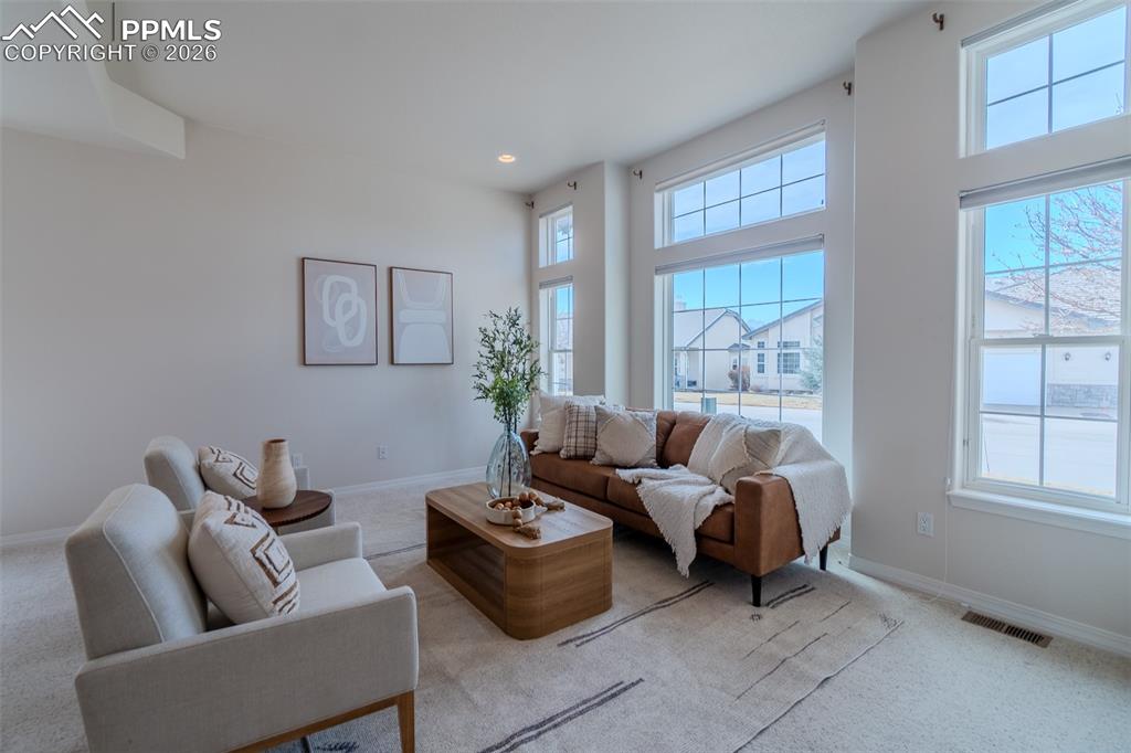 Image 3 of 50: Living area featuring carpet floors, huge windows and recessed lighting
