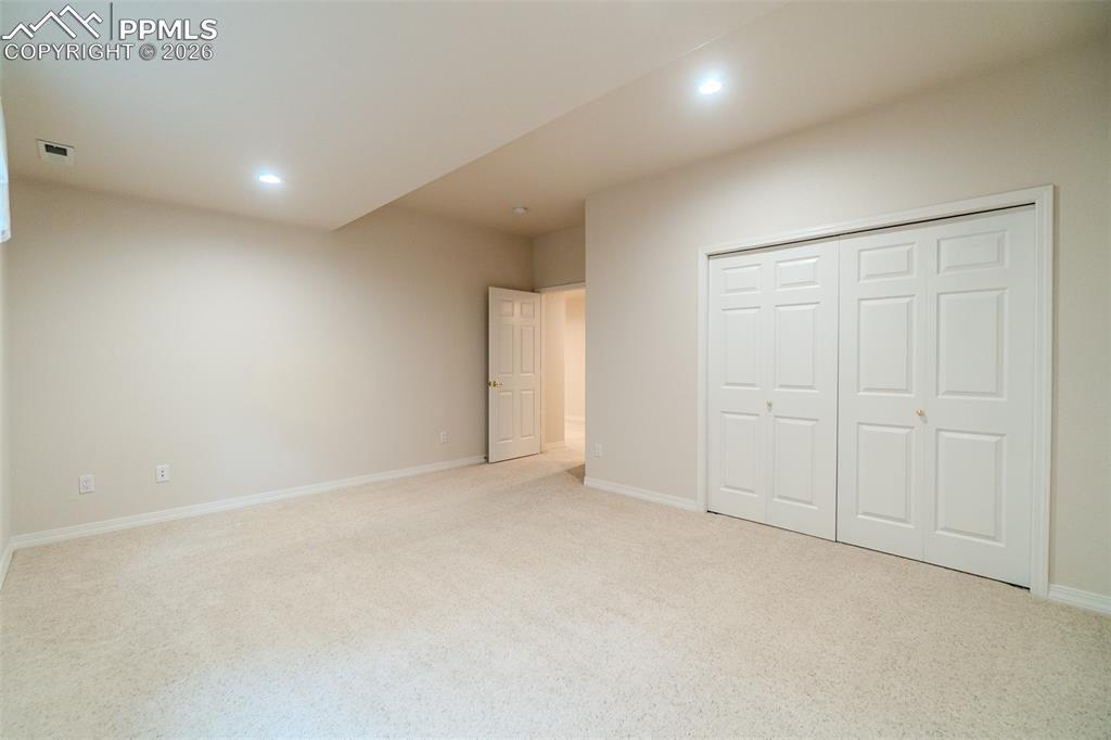 Image 39 of 50: Bedroom featuring light colored carpet, recessed lighting, and a closet