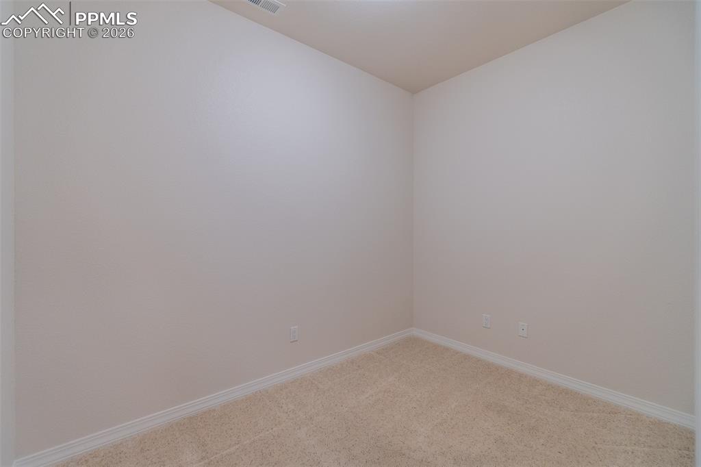 Image 40 of 50: Unfurnished room with carpet floors and baseboards