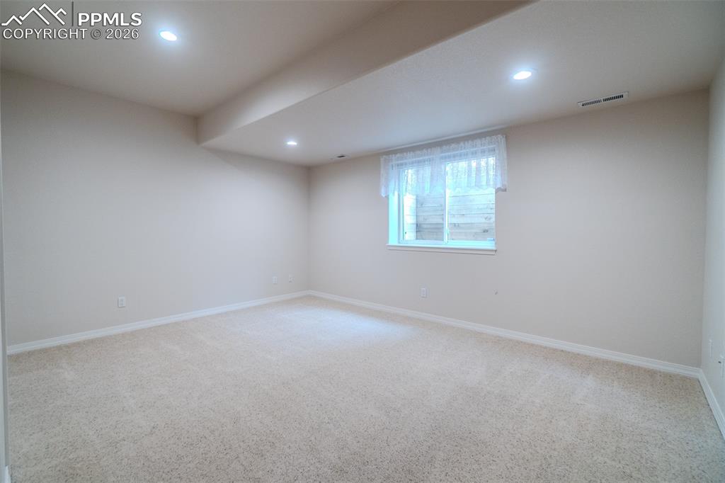 Image 43 of 50: 3rd bedroom in basement featuring light carpet and recessed lighting