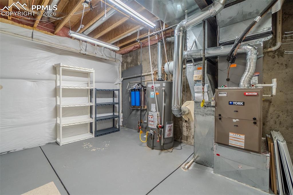 Image 44 of 50: Utility room featuring gas water heater and heating unit
