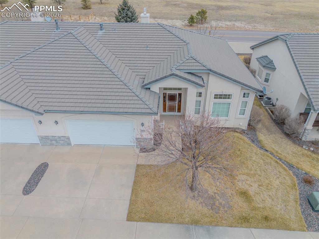 Image 48 of 50: View of front of house with a tile roof, 2 car garage, and stucco siding.