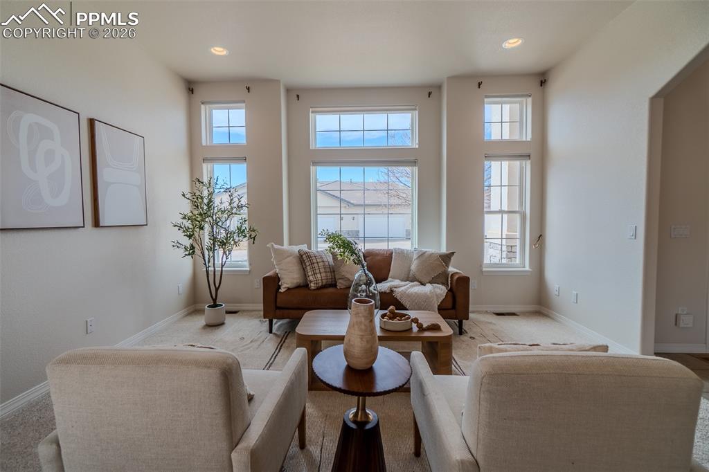 Image 5 of 50: Carpeted living room with recessed lighting