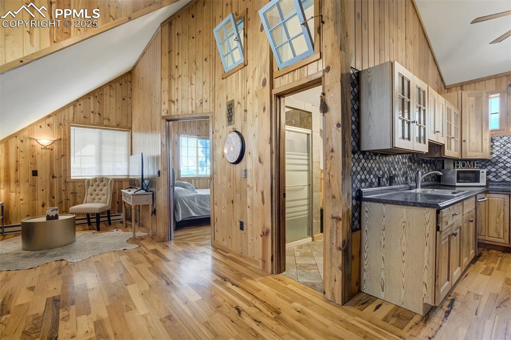 Image 38 of 50: ADU, shows living room, entrance into bedroom, bathroom and kitchen