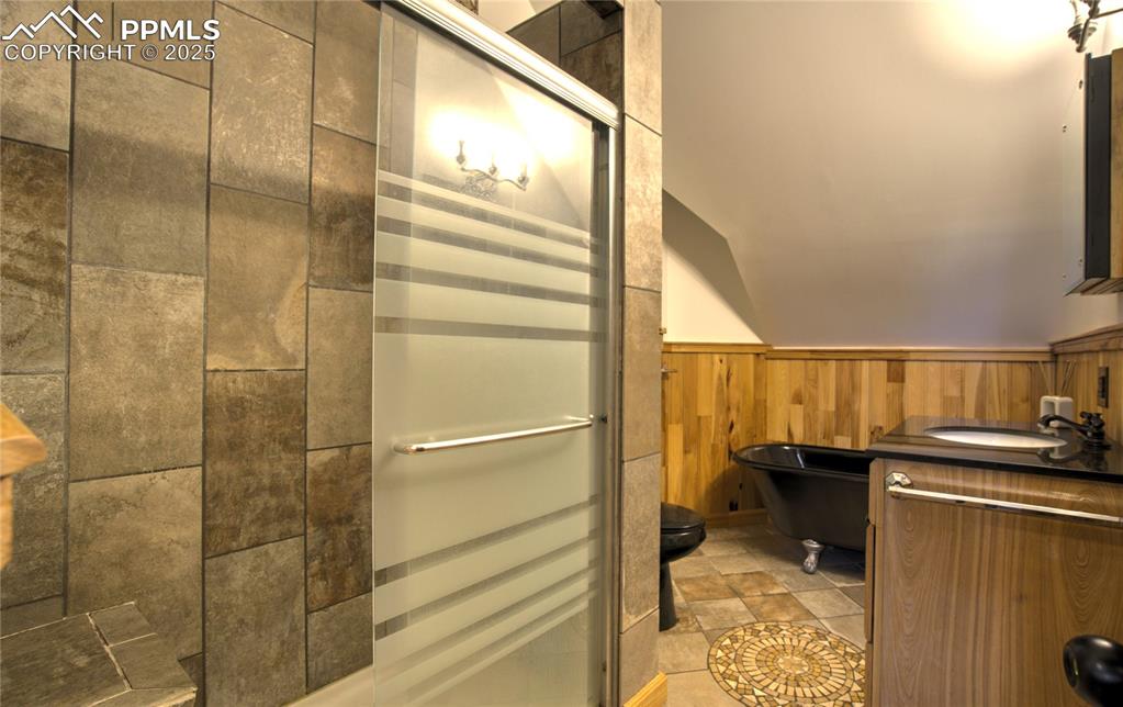 Image 48 of 50: ADU bathroom with separate shower and clawfoot tub.